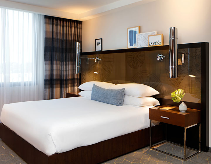 view of king bed with side tables and lighting at Kimpton Overland Hotel