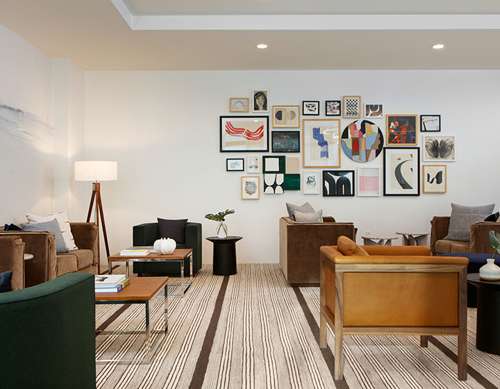 Seating and wall art in lobby of Kimpton Overland Hotel