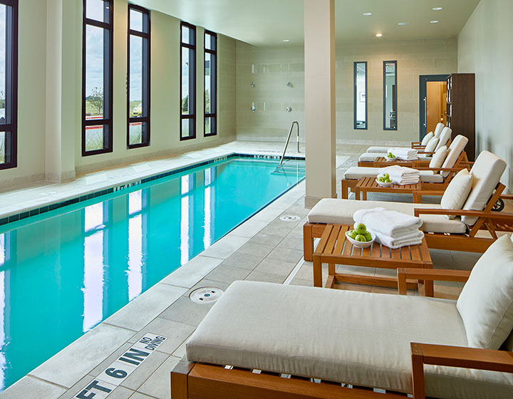 View of Kimpton Overland Hotel indoor pool and deck chairs